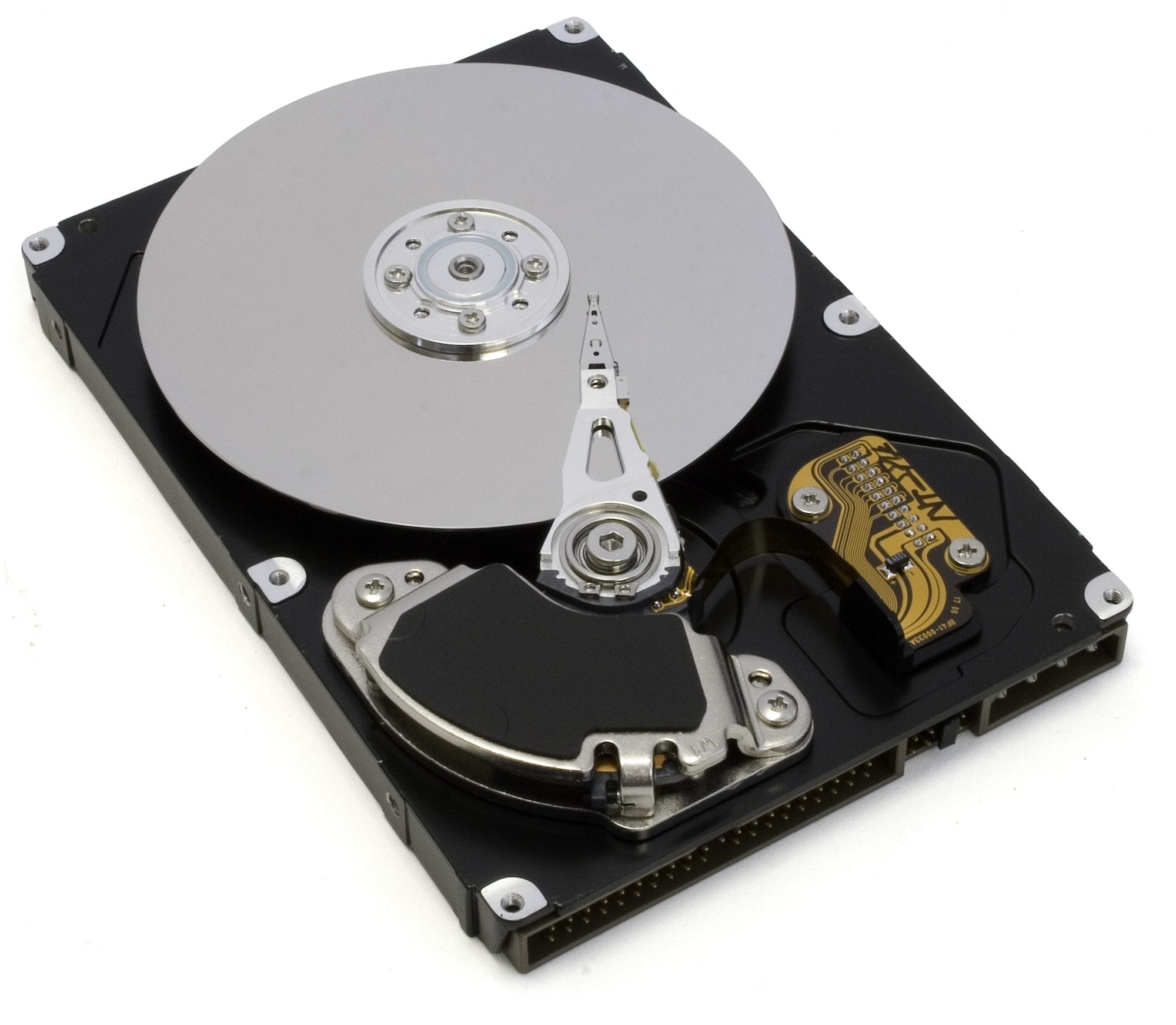An open hard drive. A shiny round platter takes up much of the case. A thin metal arm reaches over the platter, with the head at its tip.